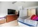 Bedroom featuring wood floors, closet, dresser, TV, and bed with colorful pillows at 1106 Summer Way Ct, Shelbyville, IN 46176