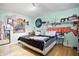 Bedroom featuring colorful graffiti wall art, wood floors, and a large window at 1106 Summer Way Ct, Shelbyville, IN 46176