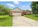 Attractive single-Gathering brick home boasting a large driveway and an attached two-car garage at 1106 Summer Way Ct, Shelbyville, IN 46176
