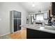 Bright kitchen with two-toned cabinets, stainless steel refrigerator, and breakfast bar at 1106 Summer Way Ct, Shelbyville, IN 46176