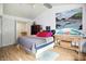 A bright main bedroom featuring a vaulted ceiling, a large bed, artistic decor, and plenty of natural light at 1106 Summer Way Ct, Shelbyville, IN 46176