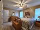 Comfortable bedroom with neutral decor, a ceiling fan, and a warm, inviting atmosphere at 1223 Long Shore Dr, Indianapolis, IN 46217