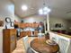Well-lit kitchen featuring stainless steel appliances, wood cabinetry, and an adjacent dining area at 1223 Long Shore Dr, Indianapolis, IN 46217