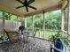 Relaxing screened porch with a table and chairs, offering a serene view of the backyard at 1223 Long Shore Dr, Indianapolis, IN 46217