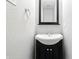 Bathroom featuring a black vanity with chrome fixtures, a square mirror, and a white sink at 1236 N Aberdeen Dr, Franklin, IN 46131