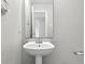 Small bathroom with pedestal sink, mirror, and neutral walls at 1236 N Aberdeen Dr, Franklin, IN 46131