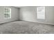 Bright bedroom features neutral walls and carpet, with two large windows for ample natural light at 1236 N Aberdeen Dr, Franklin, IN 46131