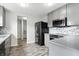 Galley kitchen featuring stainless steel appliances, gray cabinets, and hexagonal backsplash at 1236 N Aberdeen Dr, Franklin, IN 46131