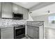 Updated kitchen with gray cabinets, stainless steel appliances, and tiled backsplash at 1236 N Aberdeen Dr, Franklin, IN 46131