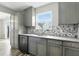 Kitchen with stainless steel appliances, gray cabinets, and a mosaic backsplash at 1236 N Aberdeen Dr, Franklin, IN 46131