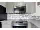 Close-up of kitchen with stainless steel oven, range, and gray cabinets at 1236 N Aberdeen Dr, Franklin, IN 46131