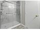 Bathroom featuring a shower with glass doors, marble paneling, and chrome fixtures at 1236 N Aberdeen Dr, Franklin, IN 46131
