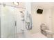 Well lit bathroom featuring a glass enclosed shower with built in shelving and a wall mounted TV at 1237 Driftwood Dr, Carmel, IN 46033