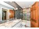 Bathroom featuring a vanity with granite top and a glass enclosed shower and bath at 1237 Driftwood Dr, Carmel, IN 46033