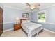 This blue bedroom has a bed with silver bedding, a window with natural light, and a small closet at 1237 Driftwood Dr, Carmel, IN 46033