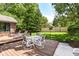 Spacious wooden deck featuring outdoor seating, a table for dining, and a view of the lush backyard at 1237 Driftwood Dr, Carmel, IN 46033
