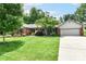 Charming brick home with a well-manicured lawn, mature trees and attached two-car garage at 1237 Driftwood Dr, Carmel, IN 46033