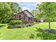Charming brick home featuring a landscaped front yard and shuttered windows at 1237 Driftwood Dr, Carmel, IN 46033