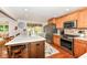 Well-lit kitchen featuring stainless steel appliances, quartz counters, and a breakfast bar at 1237 Driftwood Dr, Carmel, IN 46033