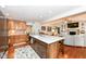 Open-concept kitchen featuring a large center island with seating, modern finishes and hardwood floors at 1237 Driftwood Dr, Carmel, IN 46033