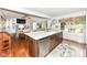Spacious kitchen with hardwood floors, island seating and open to Gathering room with fireplace at 1237 Driftwood Dr, Carmel, IN 46033