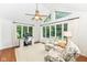 Inviting living room with sun-drenched windows, vaulted ceilings, and cozy seating area at 1237 Driftwood Dr, Carmel, IN 46033