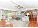 Cozy living room with hardwood floors, ceiling fan, comfortable seating and view into kitchen at 1237 Driftwood Dr, Carmel, IN 46033