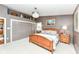 Spacious main bedroom featuring a wooden bed frame, built-in storage and a decorative chandelier at 1237 Driftwood Dr, Carmel, IN 46033