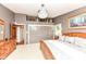 This main bedroom boasts spacious closets, shelving and a wooden bedframe with a decorative chandelier at 1237 Driftwood Dr, Carmel, IN 46033