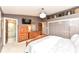Bright main bedroom with wood furniture, closets, decorative shelving, and an ensuite bathroom at 1237 Driftwood Dr, Carmel, IN 46033