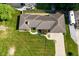 Aerial view showcasing the home's roof, landscaped yard, driveway, and surrounding greenery at 136 W Loretta Dr, Indianapolis, IN 46217
