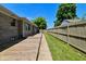 Backyard featuring a wood deck, fenced yard, and mature trees at 136 W Loretta Dr, Indianapolis, IN 46217