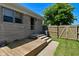 Backyard with deck, patio, fenced yard, and stone exterior home at 136 W Loretta Dr, Indianapolis, IN 46217