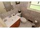 The bathroom showcases leopard print wallpaper, a wood cabinet vanity, and a white toilet at 136 W Loretta Dr, Indianapolis, IN 46217