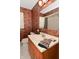 Bathroom featuring a sink, mirror, toilet and shower/tub with safari themed wallpaper at 136 W Loretta Dr, Indianapolis, IN 46217