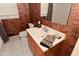 A well-lit bathroom features a sink, mirror, toilet and unique safari themed wallpaper at 136 W Loretta Dr, Indianapolis, IN 46217