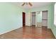 Bedroom with hardwood floors, ceiling fan, and sliding mirrored closet doors at 136 W Loretta Dr, Indianapolis, IN 46217