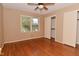 Bright bedroom features hardwood floors, closet, window, and ceiling fan at 136 W Loretta Dr, Indianapolis, IN 46217