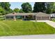Charming single-story home with stone facade, well-manicured lawn and two-car garage at 136 W Loretta Dr, Indianapolis, IN 46217
