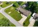 Aerial view of single-story home with large yard, driveway, and mature trees at 136 W Loretta Dr, Indianapolis, IN 46217