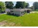 Charming single-story home featuring a lush lawn, stone facade, and mature landscaping at 136 W Loretta Dr, Indianapolis, IN 46217
