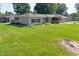 Well-maintained single-story home with stone exterior, attached garage, and expansive front lawn at 136 W Loretta Dr, Indianapolis, IN 46217