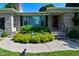 Inviting entrance with well maintained landscaping and a classic red door at 136 W Loretta Dr, Indianapolis, IN 46217