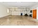 Spacious garage with a three-car door, ample lighting, and concrete floor at 136 W Loretta Dr, Indianapolis, IN 46217