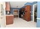 This kitchen features dark wood cabinets, white tiled floors, and stainless steel appliances at 136 W Loretta Dr, Indianapolis, IN 46217