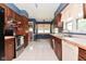 Functional kitchen with ample cabinet space, tile flooring, and stainless steel appliances at 136 W Loretta Dr, Indianapolis, IN 46217