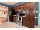 Open kitchen layout with stainless steel appliances, dark cabinetry, and sleek black refrigerator at 136 W Loretta Dr, Indianapolis, IN 46217