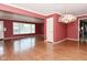 Open-concept living room with hardwood floors, large windows, and easy access to adjacent rooms at 136 W Loretta Dr, Indianapolis, IN 46217