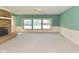 The living room is light and bright with a stone fireplace and a large bank of windows at 136 W Loretta Dr, Indianapolis, IN 46217