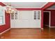 Spacious living room featuring built-in cabinetry, hardwood floors, and a decorative chandelier at 136 W Loretta Dr, Indianapolis, IN 46217